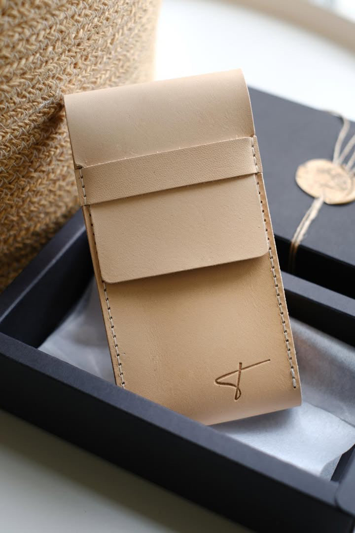 Natural Tärnsjö leather watch pouch leaning against a black Talecraft box with a wax seal